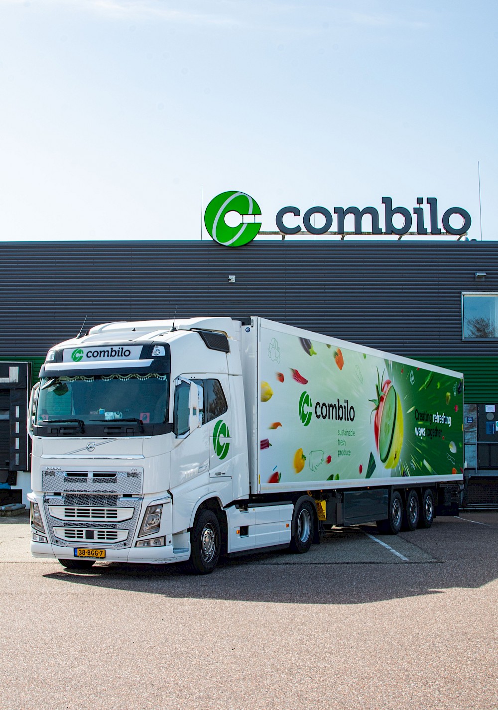 A white truck with the logo "Combilo" parked in front of a building