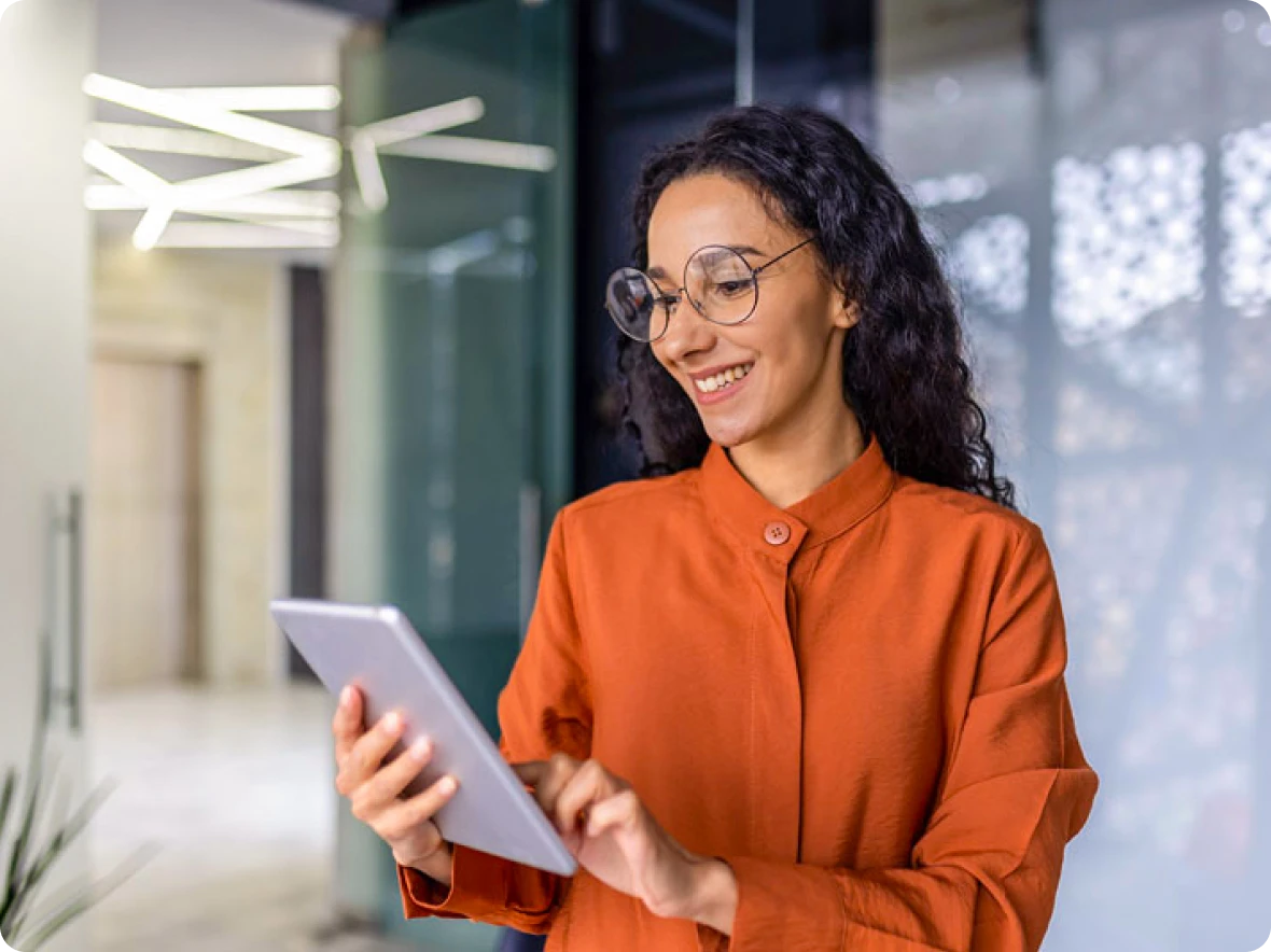 woman with glasses looking at tablet