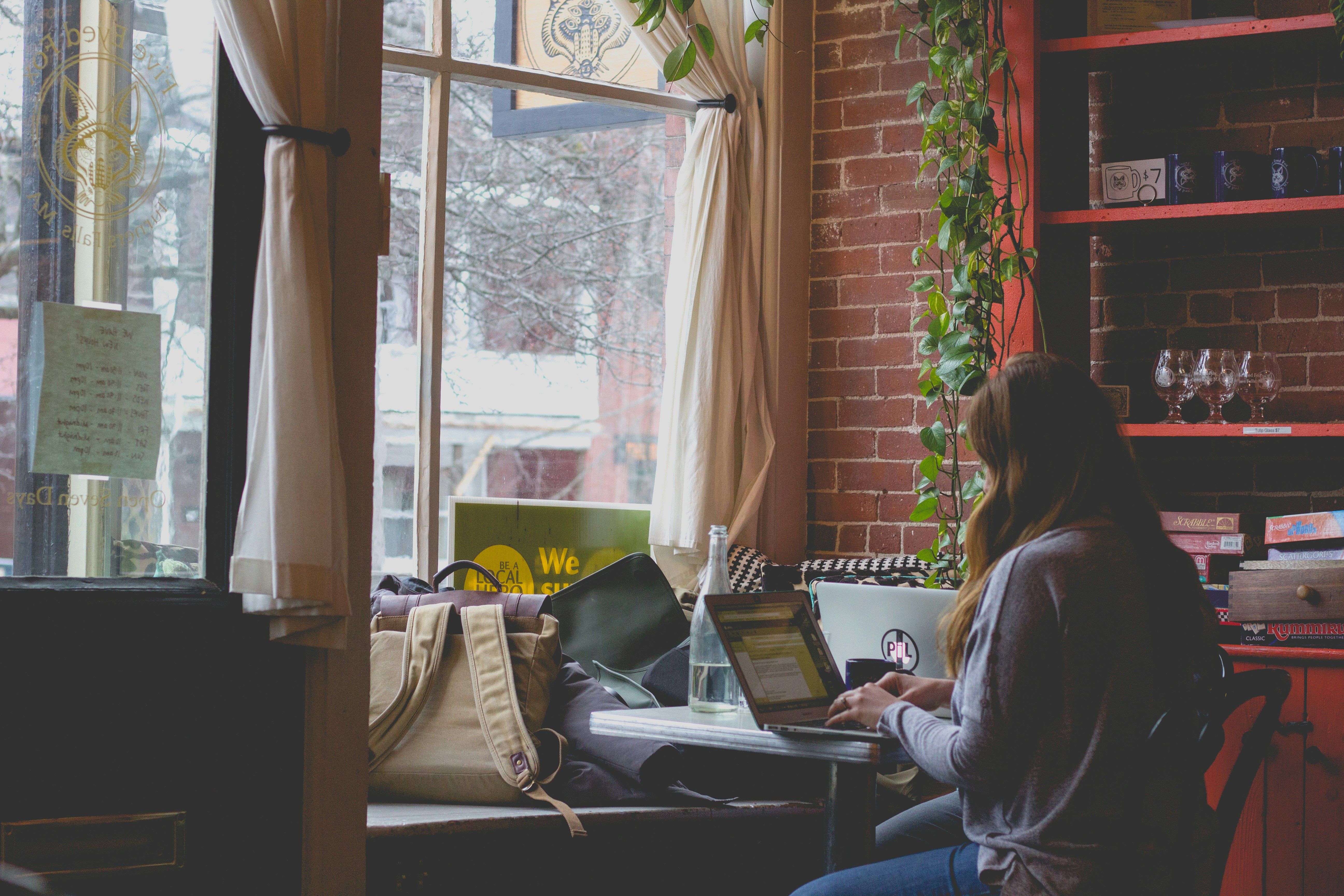 woman working from home with large window